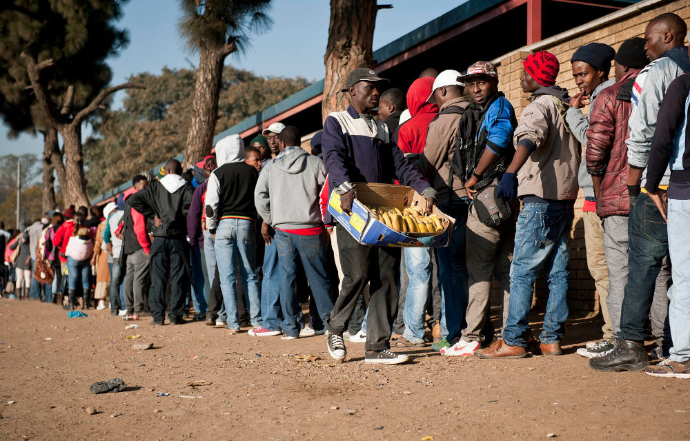 Asylum seekers wait to apply for permits at Home Affairs in Marabastad. The Help@Hand app helps refugees and asylum seekers to access services.