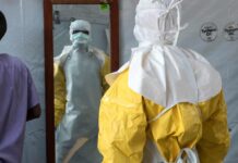 ‘Most complex health crisis in history’: Congo struggles to contain Ebola Man in Ebola protection suit.