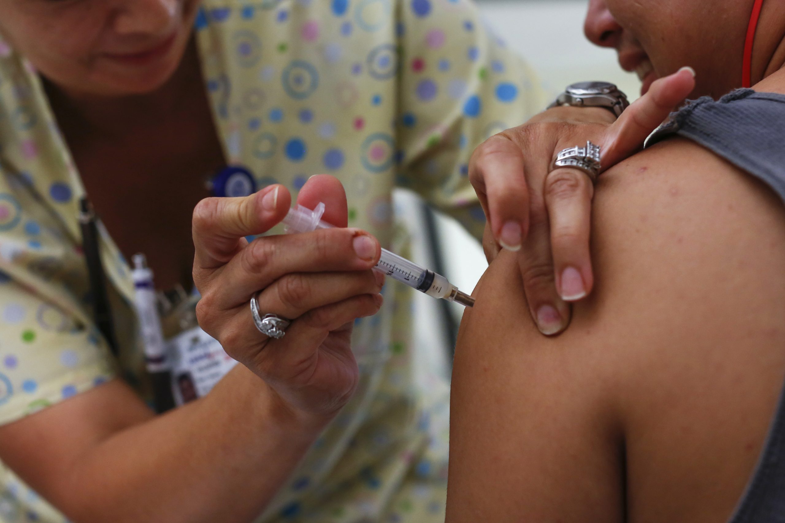 A teenager receives a vaccination