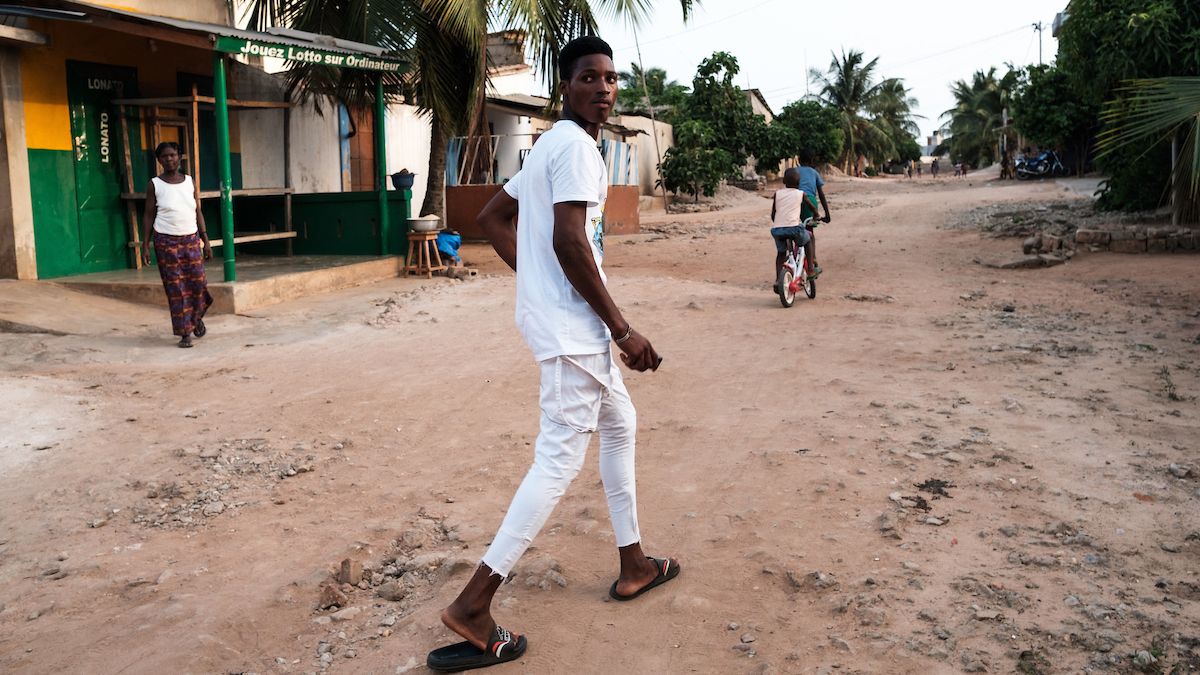 Doing the ‘tramadol dance’: What this latest music craze says about Africa’s pill addiction Man walking on a dirt road in Togo.