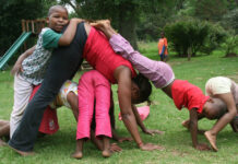 A mother to 30; a nurse to thousands Chanda Mollers teaches yoga to Sister Abegail Nhleko's children.