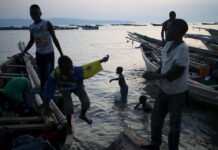 Fishing and family planning – how the two are linked Boys prepare fishing boats for night fishing in Lake Tanganyika at sunset.