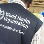 A World Health Organization official looks on as health workers in Conakry receive training during the 2015 Ebola outbreak in West Africa.