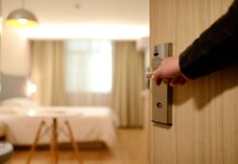 Wanderlust during the pandemic: Should you swim in a hotel’s pool? Person Holding on Door Lever Inside Hotel Room