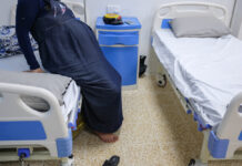 Headaches, heartaches & pregnancy: Could this stem preeclampsia’s deadly tide? A pregnant woman sits on a hospital bed.