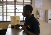 mhealth’s power & pitfalls: An SMS a day keeps teens alive Man scans his fingerprint to receive medication.