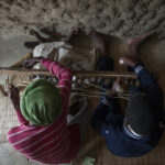 Zanele sits alongside her 13-year-old son