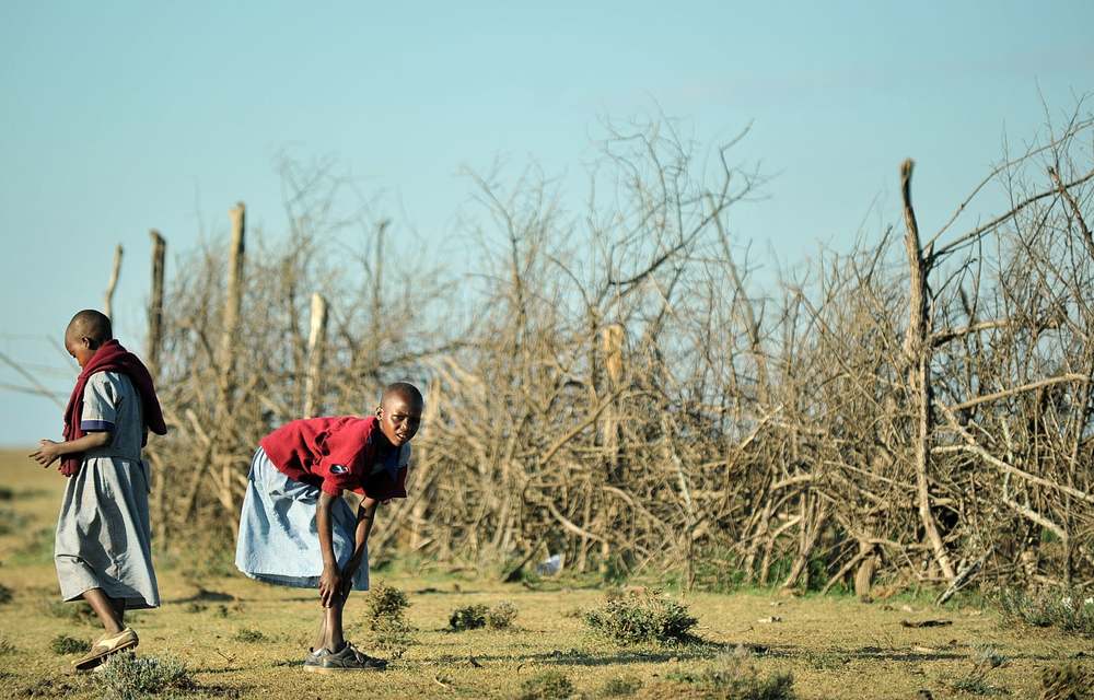 Young Maasai girls leave their village near Narok to go to school. Campaigners say addressing poverty and gender-based violence in the area is vital.