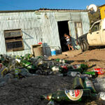 A young child at the doorway to a tavern in Imizamo Yethu in Hout Bay